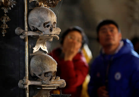 Visitors observe medieval human skulls at the Sedlec Ossuary in Kutna Hora, Czech Republic, February 14, 2019. REUTERS/David W Cerny