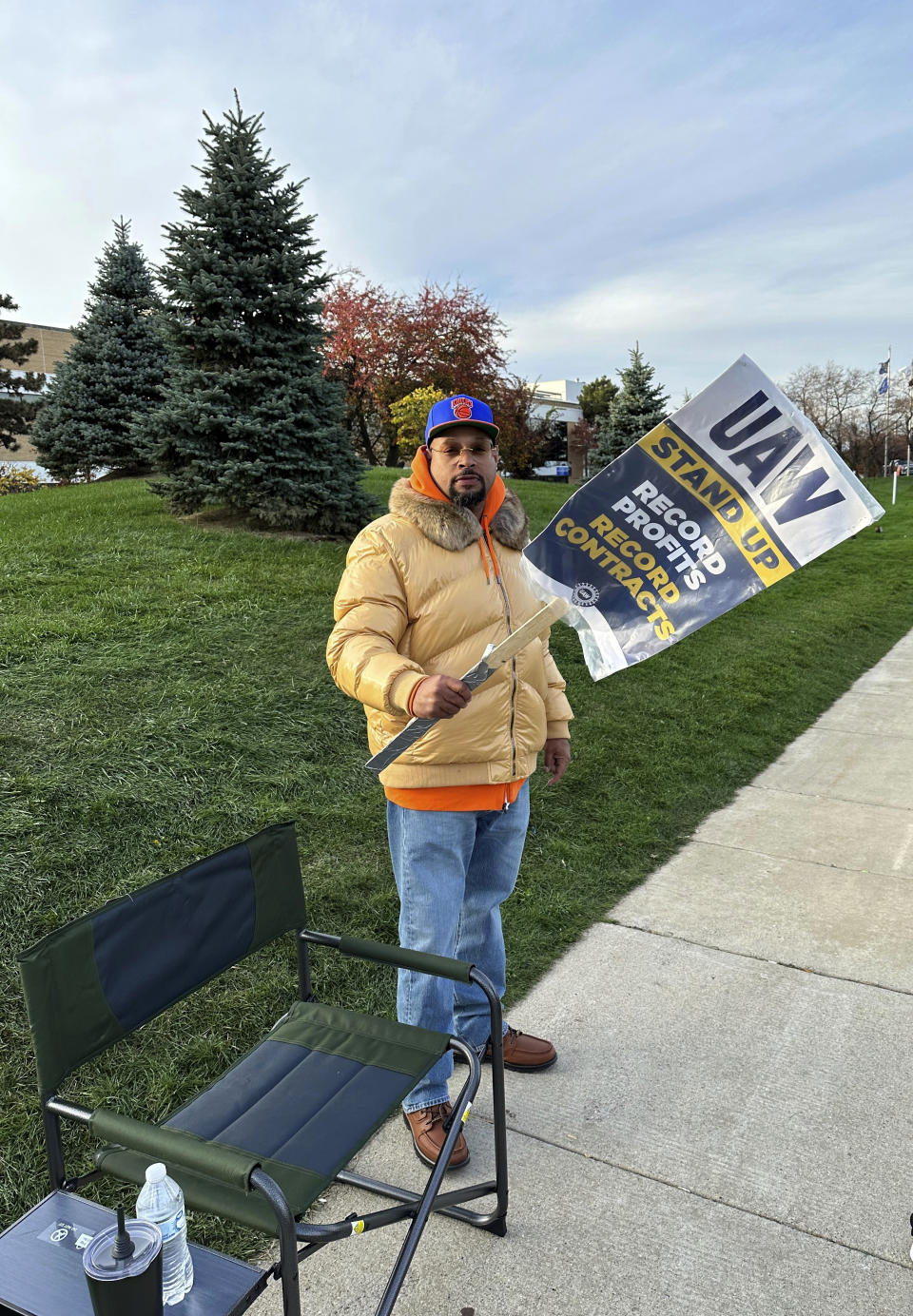 Stellantis employee and United Auto Workers member DeSean McKinley walks the picket line Saturday, Oct. 28, 2023, outside the automaker's Sterling Heights Assembly, Mich., plant. McKinley called the tentative agreement between the UAW and Stellantis "a blessing." "A new contract for me ... I have a son in college. I have a wife. I have a grandson on the way. It means I can take care of my family and better prepare for the future," McKinley said. (AP Photo/Corey Williams)