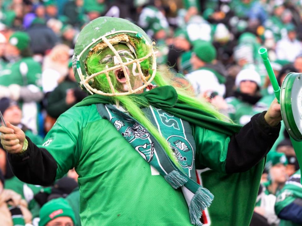 A Saskatchewan Roughriders fan is shown at the 2013 Grey Cup game in Regina. For this year's game, hundreds of tickets are now up for resale. (Frank Gunn/The Canadian Press - image credit)