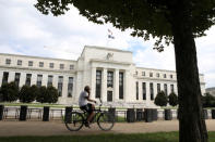 FILE PHOTO: A cyclist passes the Federal Reserve building in Washington, DC, U.S., August 22, 2018. REUTERS/Chris Wattie/File Photo