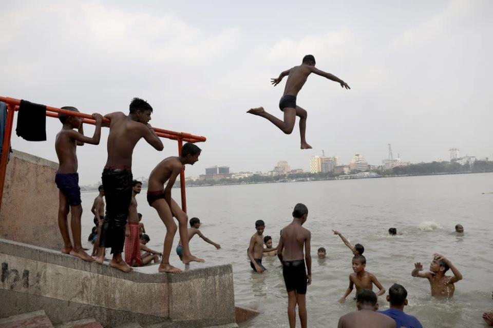A boy dives into the Ganges River during a hot day in Kolkata, India. (EPA)