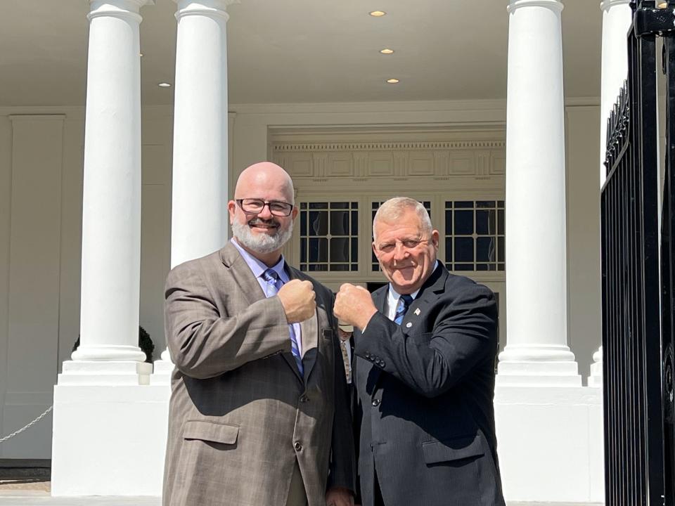 Mike Partain, left, and Jerry Ensminger bump fists in August 2022 outside of the White House after the signing of a bill that gave people who lived and worked at Camp Lejeune and became ill from contaminated water the right to sue the federal government. Partain and Ensminger have led a fight for many years to get help for Camp Lejeune victims.