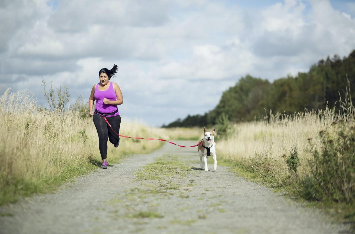 Despite the promise of drugs that can help people shed pounds, healthy lifestyle choices are still key to overall health. <a href="https://www.gettyimages.com/detail/photo/woman-running-with-dog-royalty-free-image/627573747?phrase=overweight+people&adppopup=true" rel="nofollow noopener" target="_blank" data-ylk="slk:Zing Images / DigitalVision via Getty Images;elm:context_link;itc:0;sec:content-canvas" class="link ">Zing Images / DigitalVision via Getty Images</a>