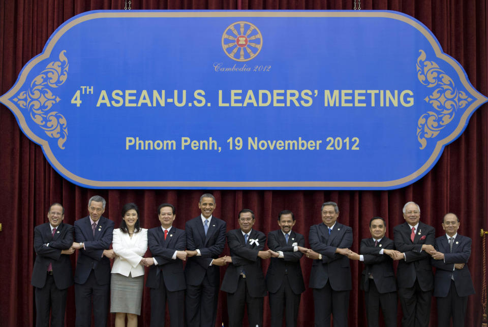 U.S. President Barack Obama, fifth from left, stands hand in hand with ASEAN leaders for a family photo during the ASEAN-U.S. leaders' meeting at the Peace Palace in Phnom Penh, Cambodia, Monday, Nov. 19, 2012. They are, from left, Philippines' President Benigno Aquino III, Singapore's Prime Minister Lee Hsien Loong, Thailand's Prime Minister Yingluck Shinawatra, Vietnam's Prime Minister Nguyen Tan Dung, Obama, Cambodia's Prime Minister Hun Sen, Brunei's Sultan Hassanal Bolkiah, Indonesia's President Susilo Bambang Yudhoyono, Laos Prime Minister Thongsing Thammavong, Malaysia's Prime Minister Najib Razak and Myanmar's President Thein Sein. (AP Photo/Carolyn Kaster)