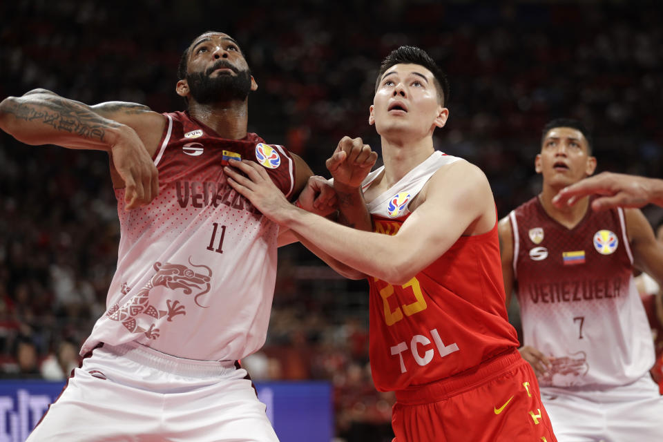 Luis Bethelmy of Venezuela and Abudushalamu Abudurexiti of China battle for a rebound during their group phase game in the FIBA Basketball World Cup at the Cadillac Arena in Beijing, Wednesday, Sept. 4, 2019. (AP Photo/Mark Schiefelbein)