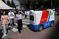 Autonomous delivery vehicle by JD Logistics operates on a street in Beijing