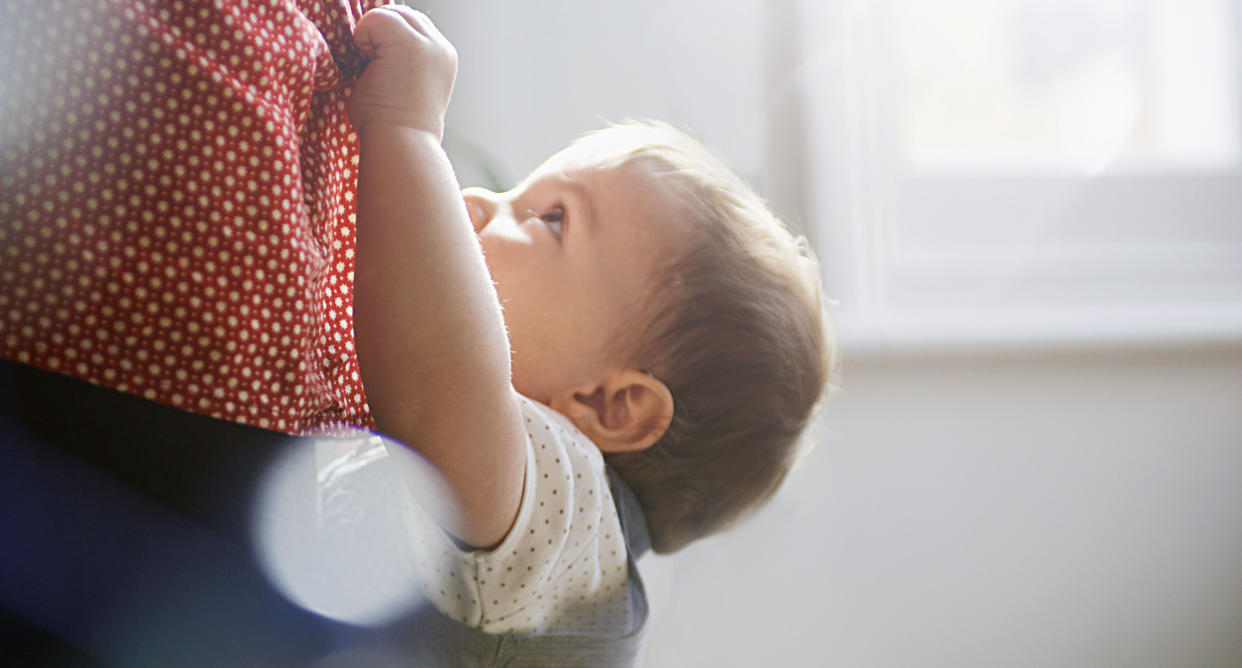 Is your little one always wanting to be held? Here's how to set some boundaries — and get a bit of space. (Photo: Getty)