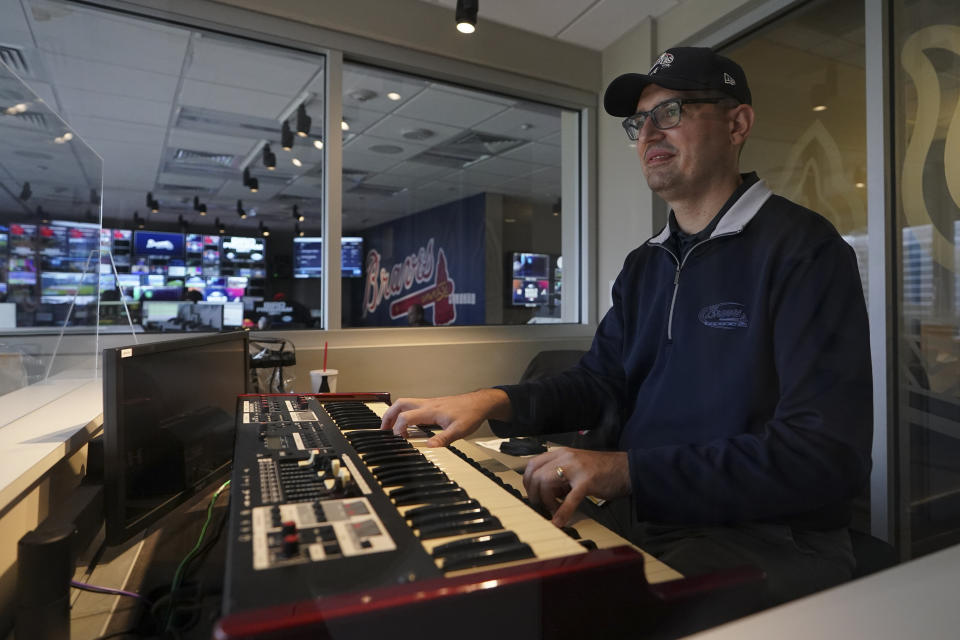 FILE - Atlanta Braves' organist Matthew Kaminski plays an organ overlooking Truist Field before Game 4 of baseball's World Series between the Houston Astros and the Atlanta Braves Oct. 30, 2021, in Atlanta. The jazz lover's eclectic taste in music, and his hilarious selections when opposing players come to the plate, set up a game within every game. For the first time ever, we'll be awarding a Newby Grammy to our top sports-related musician, Kaminski. (AP Photo/Brynn Anderson, File)