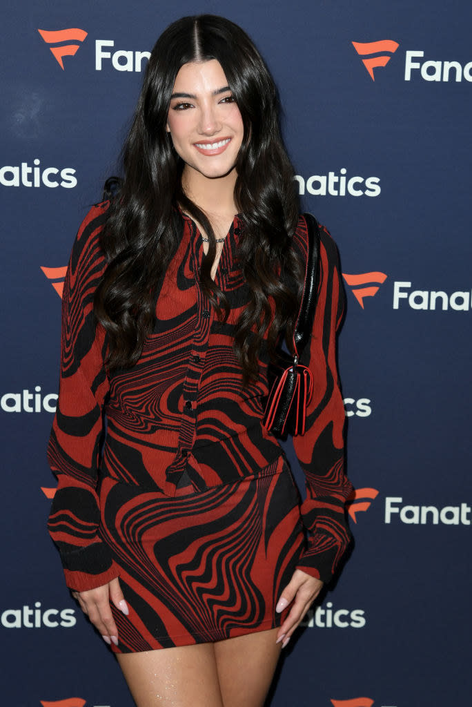 Charli at in an event wearing a red dress
