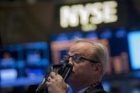 A trader looks up at a screen on the floor of the New York Stock Exchange May 1, 2014. REUTERS/Brendan McDermid