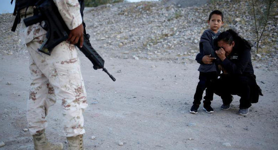 Lety Perez in hysterics with her son after they were stopped by National Guard soldiers from crossing the Mexican border into the United States. 