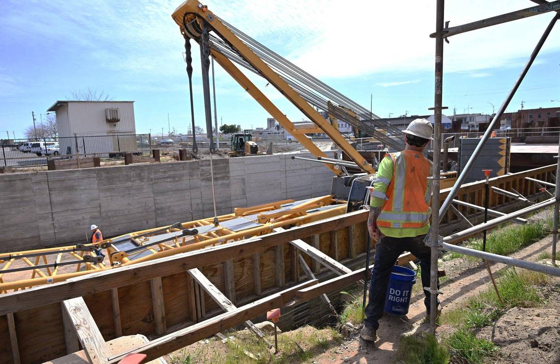 A worker steps around scaffolding at the Tulare Street underpass construction site during a tour of High Speed Rail development Friday. March 22, 2024 in downtown Fresno.