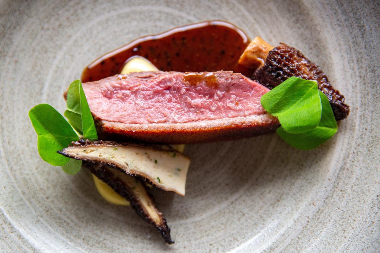 Dry-aged duck with chicken-stuffed morels, wood sorrels and topped with a sauce made with duck bones and chilis at Proof in Des Moines, Tuesday, March 22, 2022.