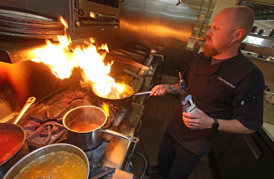 Daniel Caudill, a former chef at Estia's Kouzina, works in the kitchen at the Belmont restaurant in this January 2022 Gazette file photograph.