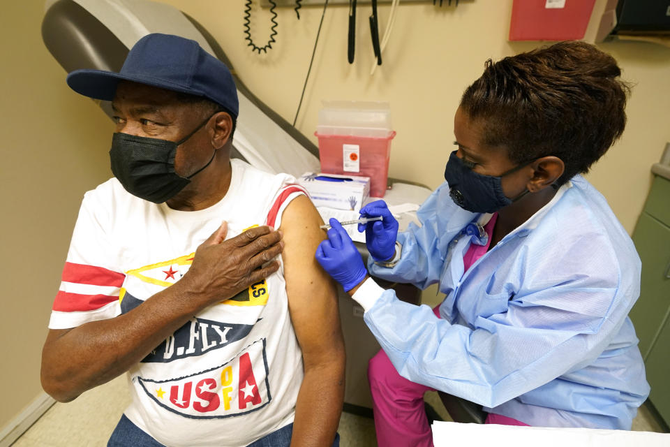 Wilbert Marshall, 71, looks away while receiving a COVID-19 vaccine, from Melissa Banks, right, a nurse at the Aaron E. Henry Community Health Service Center in Clarksdale, Miss., Wednesday, April 7, 2021. Marshall was among a group of seniors from the Rev. S.L.A. Jones Activity Center for the Elderly who received a vaccination. The Mississippi Department of Human Services is in the initial stages of teaming up with community senior services statewide to help older residents get vaccinated. (AP Photo/Rogelio V. Solis)