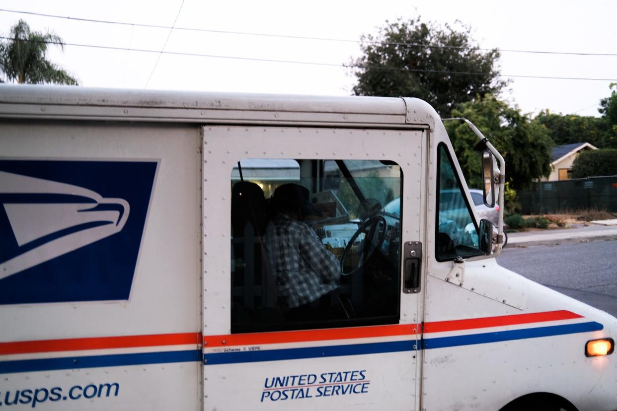 A mail truck on the streets.