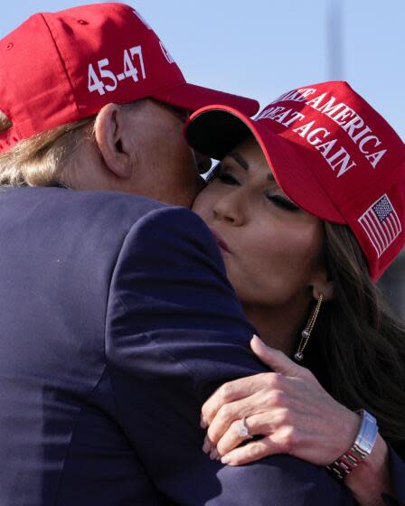 Republican presidential candidate and former President Donald Trump, left, embraces South Dakota Gov. Kristi Noem at a campaign rally Saturday, March 16, 2024, in Vandalia, Ohio. (AP Photo/Jeff Dean)