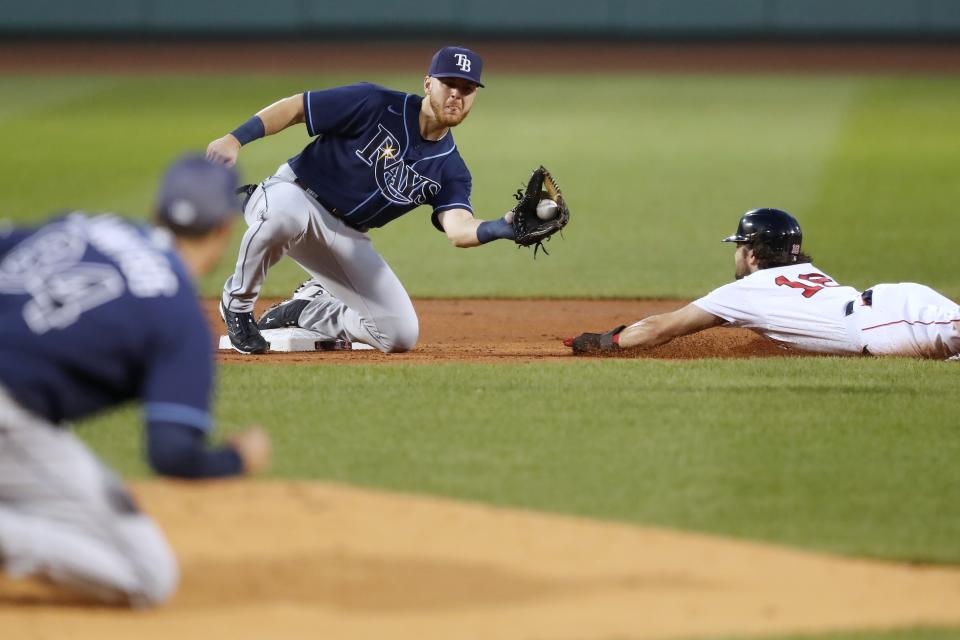 Tampa Bay Rays' Michael Brosseau, center, gets the throw at second base on the attempted steal by Boston Red Sox's Andrew Benintendi during the first inning of a baseball game, Tuesday, Aug. 11, 2020, in Boston. (AP Photo/Michael Dwyer)