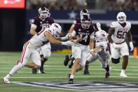 Texas A&M quarterback Max Johnson (14) carries the ball as Arkansas defensive lineman Landon Jackson (40) and linebacker Drew Sanders (42) defend during the second half of an NCAA college football game Saturday, Sept. 24, 2022, in Arlington, Texas. Texas A&M won 23-21. (AP Photo/Brandon Wade)