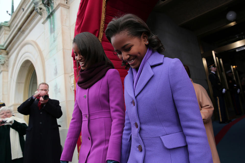 In 2013, Malia wore J.Crew’s magenta coat while Sasha chose a Kate Spade purple coat. (Photo: Getty Images)