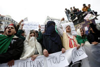 Students wearing traditional clothes hold banners and shout slogans during a protest calling on President Abdelaziz Bouteflika to quit, in Algiers, Algeria March 26, 2019. REUTERS/Ramzi Boudina