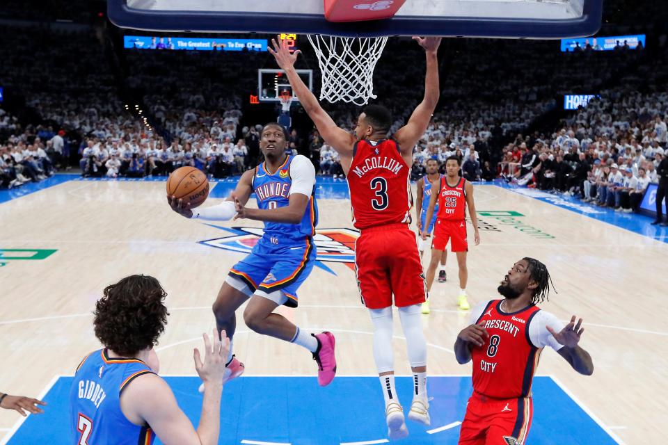 Oklahoma City Thunder forward Jalen Williams (8) puts up a shot beside New Orleans Pelicans guard CJ McCollum (3) during Game 2 of the NBA basketball playoff series between the Oklahoma City Thunder and the New Orleans Pelicans at Paycom Center in Oklahoma City, Wednesday, April 24, 2024. Oklahoma City won 124-92.