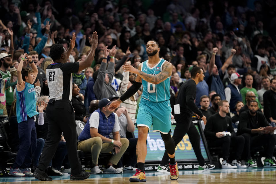 Charlotte Hornets forward Miles Bridges reacts after scoring a shot during overtime in an NBA basketball game against the Boston Celtics, Monday, Nov. 20, 2023, in Charlotte, N.C. (AP Photo/Erik Verduzco)