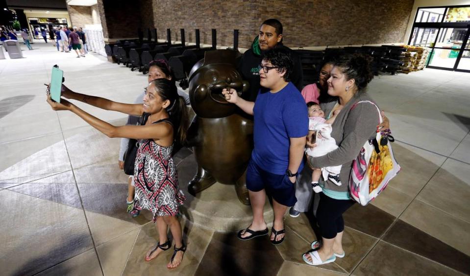 Dozens of people lined up before dawn for the May 2016 opening of Buc-ee’s in Fort Worth, including Tiffany Bonilla who took a group selfie with a bronze beaver statue.