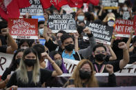 FILE - Protesters raise their clenched fists as they mark the 50th anniversary of martial law during a rally at the University of the Philippines in Manila, Philippines on Sept. 21, 2022. Philippine President Ferdinand Marcos Jr. has reaffirmed ties with the United States, the first major power he visited since taking office in June, in a key turnaround from the often-hostile demeanor his predecessor displayed toward Manila's treaty ally. (AP Photo/Aaron Favila, File)