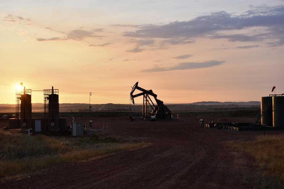 An oil well works at sunrise Aug. 25, 2021, in Watford City, N.D., part of McKenzie County. A drilling boom made McKenzie the fastest growing county in the U.S over the past decade, according to the 2020 census. (AP Photo/Matthew Brown)