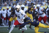 Cincinnati quarterback Brady Lichtenberg (16) is tackled by West Virginia's Marcis Floyd (24) during the first half of an NCAA college football game, Saturday, Nov. 18, 2023, in Morgantown, W.Va. (AP Photo/Chris Jackson)