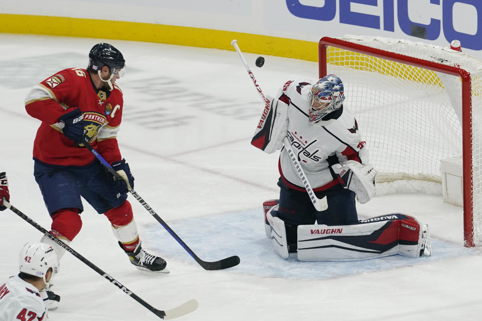 Washington Capitals goaltender Darcy Kuemper (35) stops a shot on goal by Florida Panthers center Aleksander Barkov (16) during the second period of an NHL hockey game, Tuesday, Nov. 15, 2022, in Sunrise, Fla. (AP Photo/Marta Lavandier)