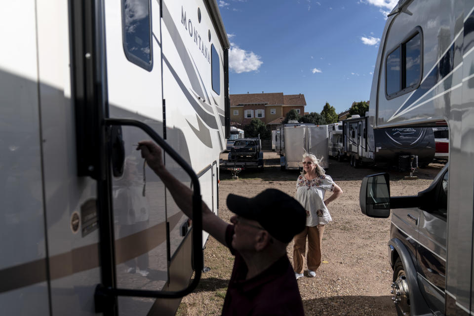 Lonnie Phillips, left, opens the RV he and his wife, Sandy, right, used to travel from one mass shooting to another, as it sits in a storage lot in Longmont, Colo., Monday, Sept. 4, 2023. Before Sandy’s daughter, Jessica Ghawi, was killed in a 2012 mass shooting in a movie theater, when headlines flashed of Columbine and Virginia Tech and Fort Hood and so many others, she absorbed the horror of it all for just a moment before turning away and returning to her safe and happy life. Something had to be done, she knew, but she left the task to others. (AP Photo/David Goldman)