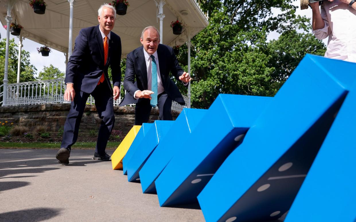 Sir Ed Davey, the Lib Dem leader, and Lib Dem candidate Gideon Amos, play with giant dominoes in Vivary Park in Taunton
