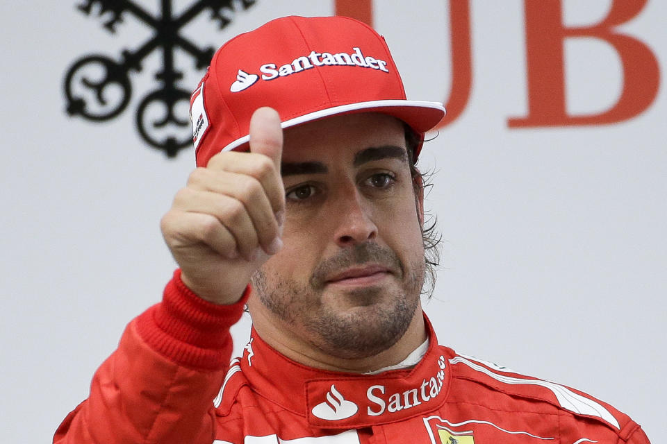 Ferrari driver Fernando Alonso of Spain celebrates after finishing the third place at the Chinese Formula One Grand Prix at Shanghai International Circuit in Shanghai, Sunday, April 20, 2014. (AP Photo/Alexander F. Yuan)