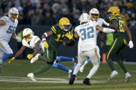 Green Bay Packers wide receiver Dontayvion Wicks (13) runs with the ball as Los Angeles Chargers safety Alohi Gilman (32) tries to stop him during the second half of an NFL football game, Sunday, Nov. 19, 2023, in Green Bay, Wis. (AP Photo/Matt Ludtke)