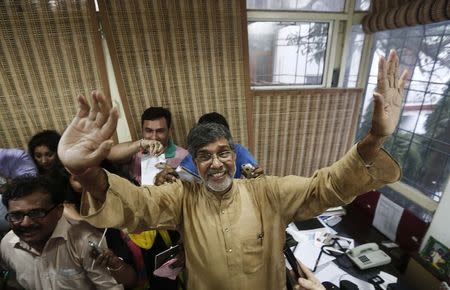 Children's right activist Kailash Satyarthi waves to the media at his office in New Delhi October 10, 2014. REUTERS/Adnan Abidi