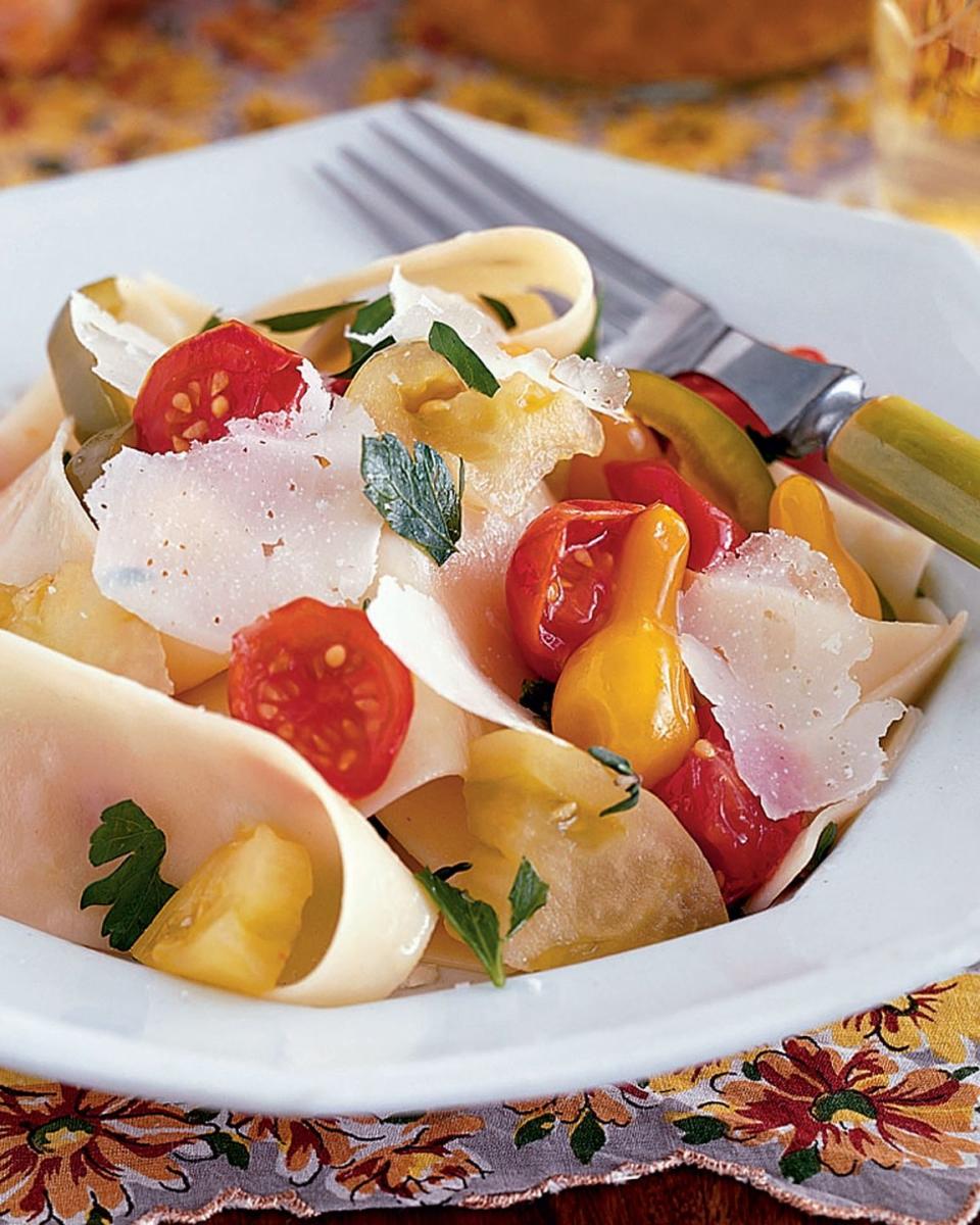 a bowl of tri tomato salad with pasta and cheese