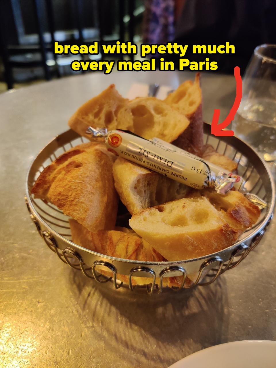 Basket of sliced bread on a table, suggesting a dining experience