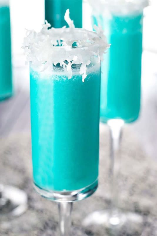 <p>Homemade Hooplah</p><p>This beautiful blue cocktail tastes like a holiday piña colada.</p><p><strong>Get The Recipe: <a href="https://homemadehooplah.com/jack-frost-cocktail/" rel="nofollow noopener" target="_blank" data-ylk="slk:Jack Frost Cocktail;elm:context_link;itc:0;sec:content-canvas" class="link ">Jack Frost Cocktail</a></strong></p>