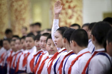 Students prepare ahead of a medal ceremony marking the 70th anniversary of the Victory of Chinese People's War of Resistance Against Japanese Aggression, for World War Two veterans, at the Great Hall of the People in Beijing, China September 2, 2015. REUTERS/Jason Lee