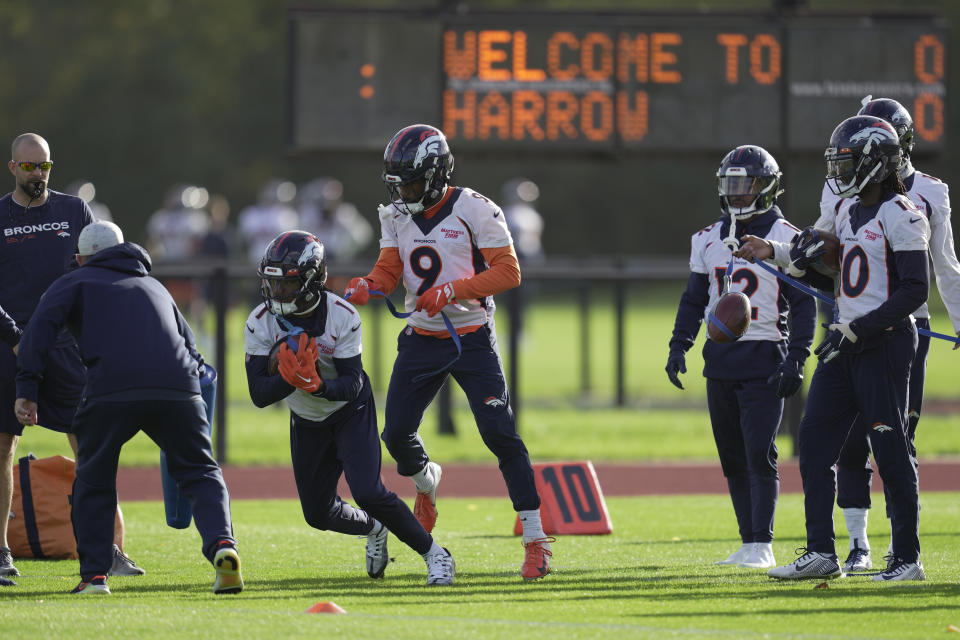 Denver Broncos KJ Hamler, (1) left, and Kendall Hinton (9) attend a practice session in Harrow, England, Wednesday, Oct. 26, 2022 ahead the NFL game against Jacksonville Jaguars at the Wembley stadium on Sunday. (AP Photo/Kin Cheung)