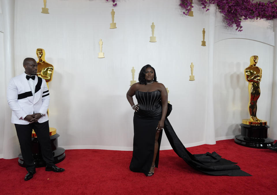 Dennis Gelin, left, and Danielle Brooks arrive at the Oscars on Sunday, March 10, 2024, at the Dolby Theatre in Los Angeles. (AP Photo/Ashley Landis)