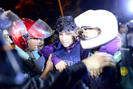 An injured member of the police personnel is carried away by his colleagues, after gunmen stormed a restaurant popular with expatriates in the diplomatic quarter of the Bangladeshi capital, in Dhaka July 1, 2016. Courtesy of Dhaka Tribune/Mahmud Hossain Opu via REUTERS