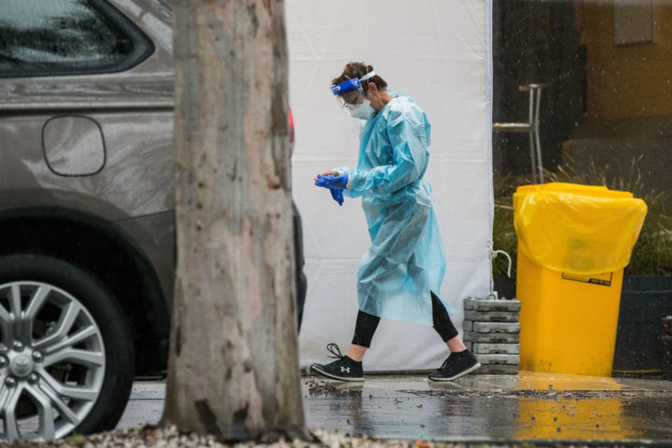 A woman wearing PPE (Personal Protective Equipment) is seen outside the Quality Hotel Carlton.