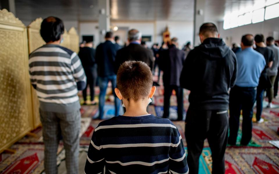 A boy praying in the temporary building of the Strasbourg Mosque - Bruno Fert