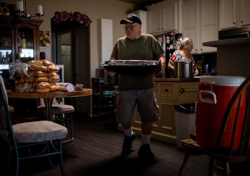 Richard “Shorty” Thornton helps his wife Norma carry food out to the car at their home in Bullhead City, Ariz., before giving serving a meal for homeless people on Tuesday, Oct. 24, 2023. | Spenser Heaps, Deseret News