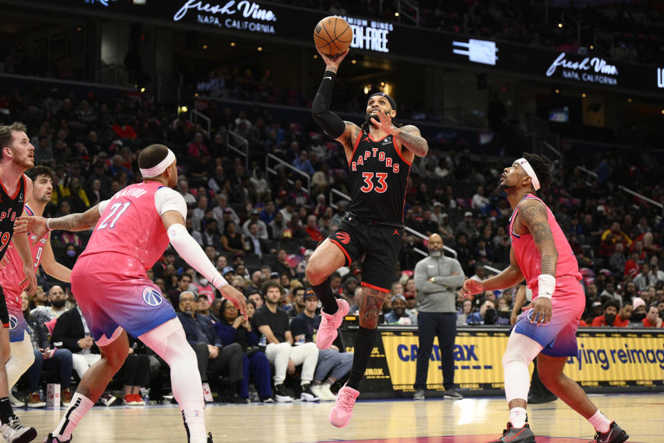 Toronto Raptors guard Gary Trent Jr. (33) goes to the basket against Washington Wizards guard Jordan Goodwin, right, and center Daniel Gafford (21) during the second half of an NBA basketball game, Thursday, March 2, 2023, in Washington. (AP Photo/Nick Wass)