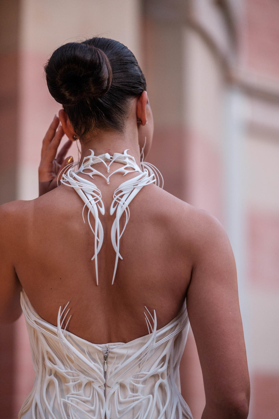 The 3D-printed elements extend beyond the bodice of the gown.