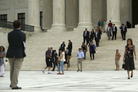Court observers depart from the front steps of the U.S. Supreme Court in Washington June 15, 2015. REUTERS/Jonathan Ernst